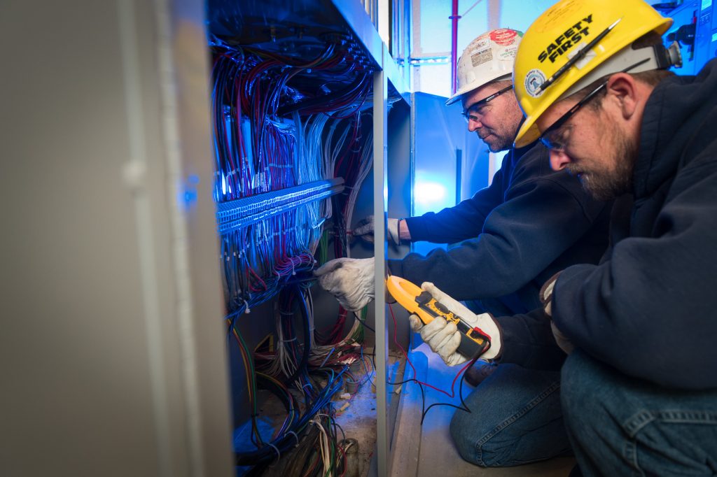 M. Davis employees testing an electrical wiring system