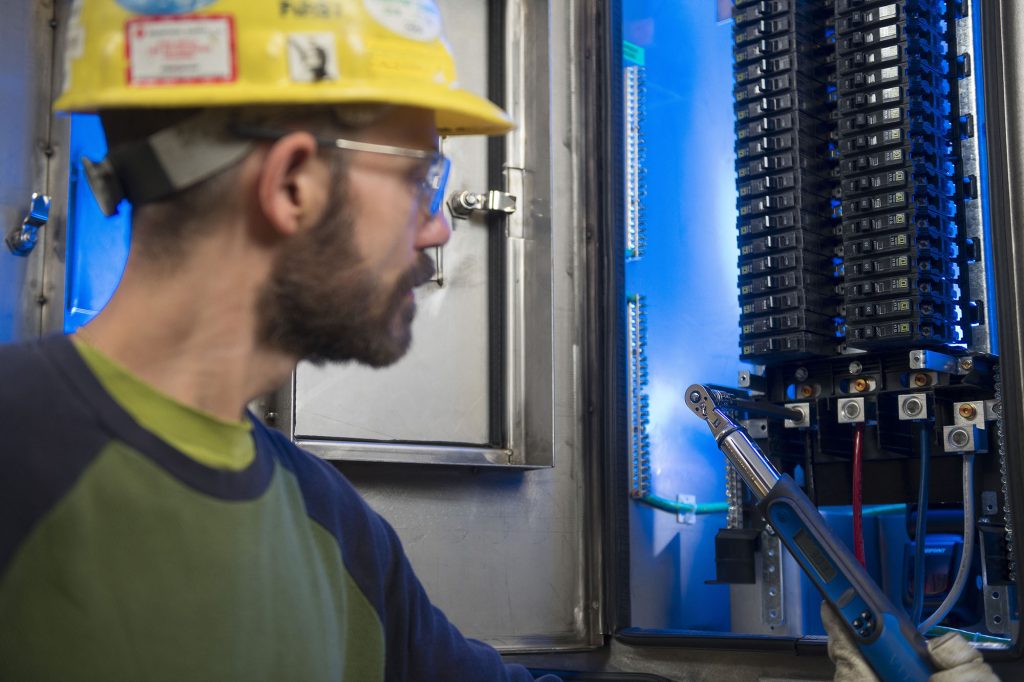 An M. Davis & Sons employee adjusting an installed UDS system