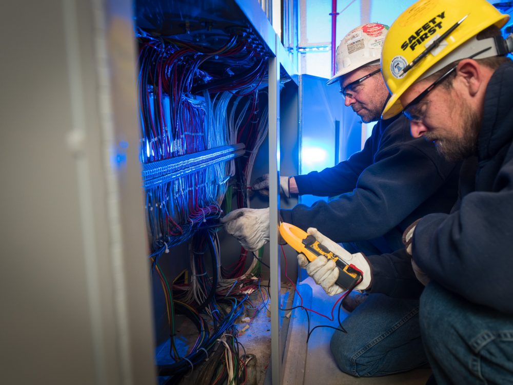 M. Davis employees testing an electrical wiring system