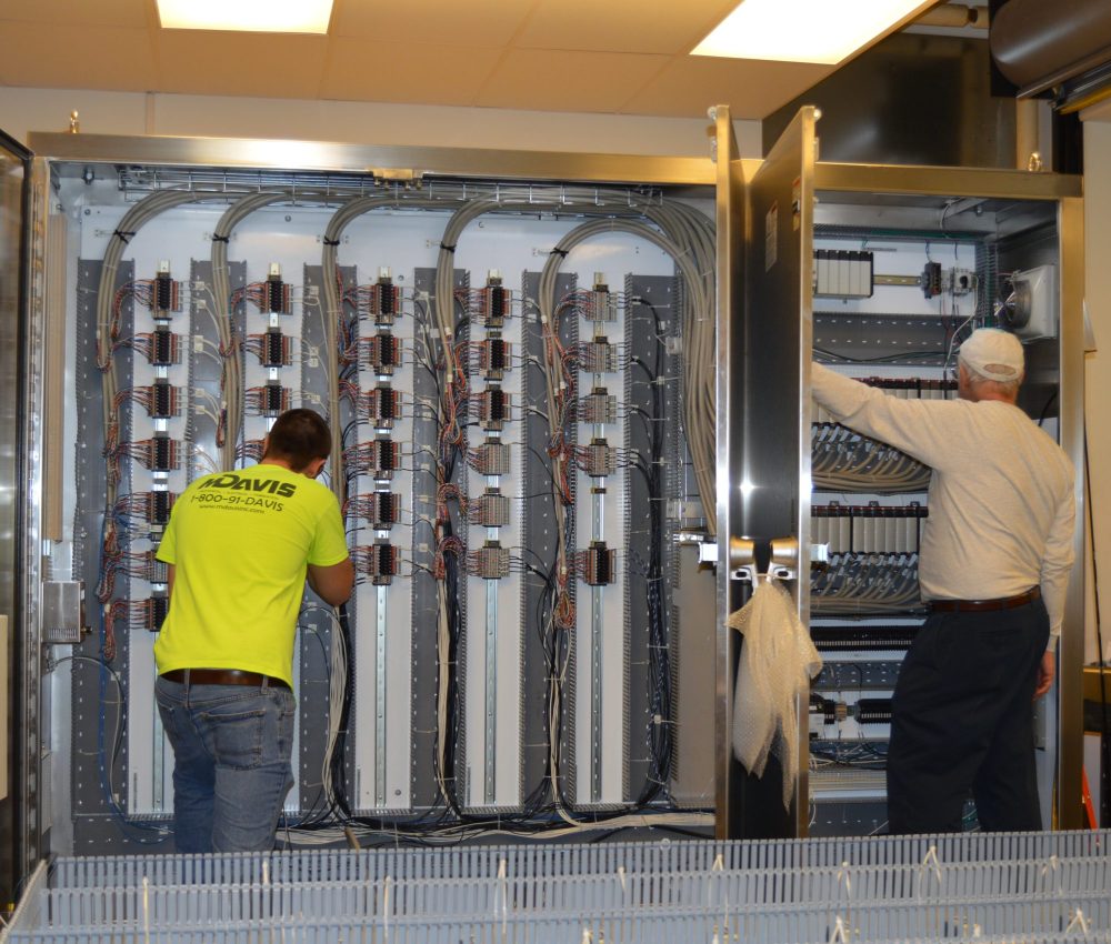 M. Davis team members working inside control panel